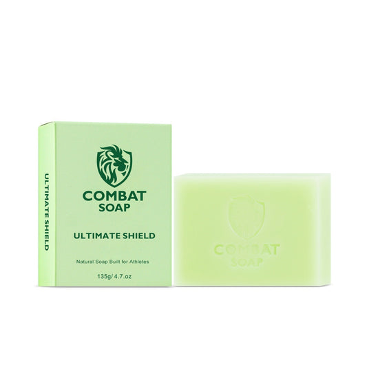 A bar of soap with a Combat Soap Holder packaging, predominantly green with the brand name and product line ' Ultimate Shield' displayed.